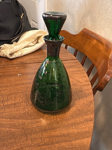 Green glass decanter with etched floral decoration and matching stopper