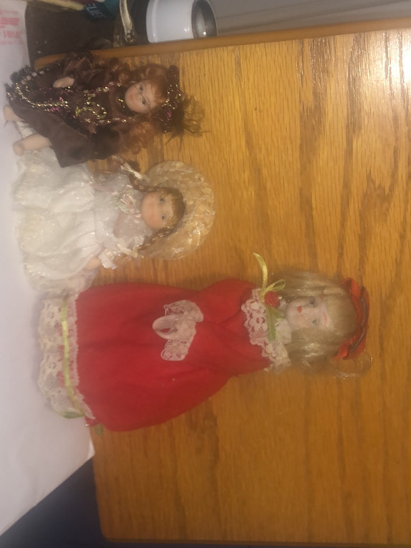 Collection of three porcelain dolls including bride, angel, and Victorian-style figure