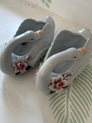 Porcelain swan figurines with applied floral decoration