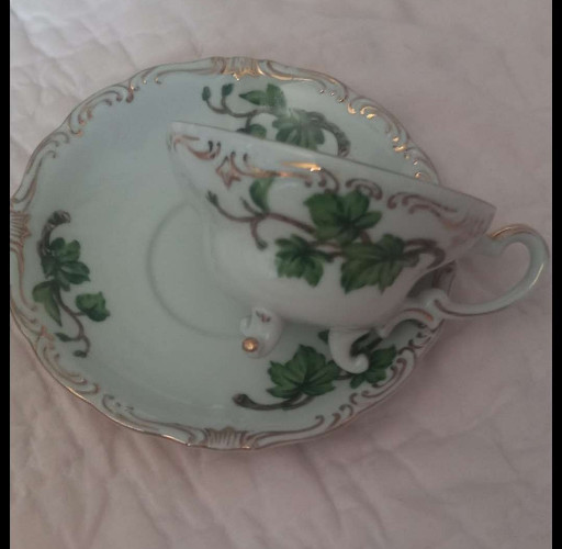 Fine bone china teacup and saucer with green ivy leaf decoration and gold trim