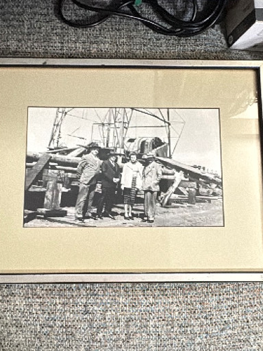 Vintage black and white photograph of fishermen on a sailing vessel