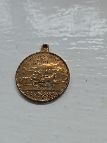 Gilt bronze medal titled 'An Irish Spinning Wheel Jaunting Car National Vehicle'