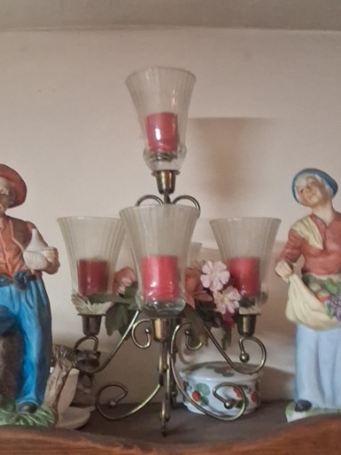 Metal candelabra with glass hurricane shades and pink-tinted glass inserts