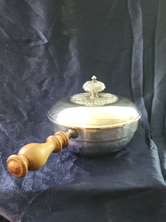 Silver-plated chafing dish with wooden handle. Makers mark an 'A' and a 'W' under a crown and 'Italy'.