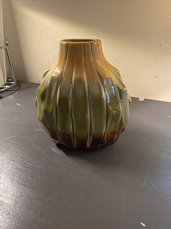 Ceramic vase with ribbed organic form and earth-tone drip glaze