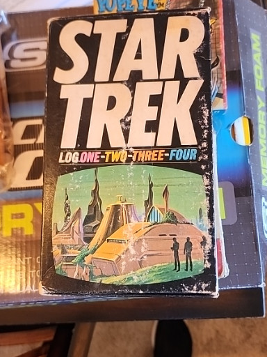Paperback book set titled 'Star Trek Log One-Two-Three-Four' by Alan Dean Foster