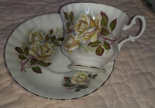 Bone china teacup and saucer set with yellow rose pattern by Royal Albert