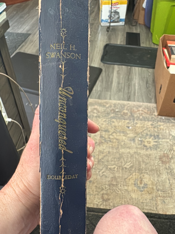 Vintage hardcover book titled 'Unconquered' by Neil H. Swanson, published by Doubleday