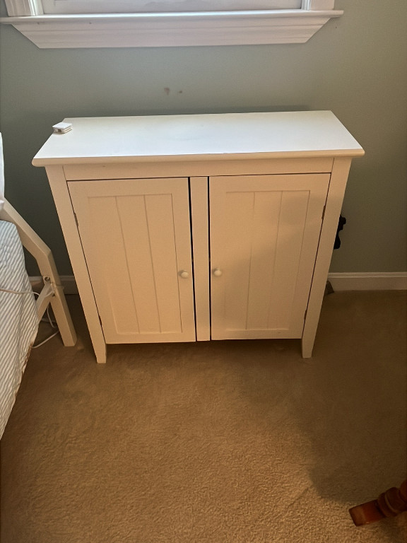 White wooden storage cabinet with double doors