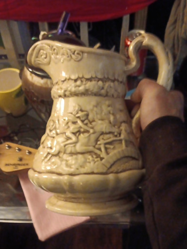 Stoneware pitcher with relief decoration titled 'Tam O'Shanter' by Ridgway