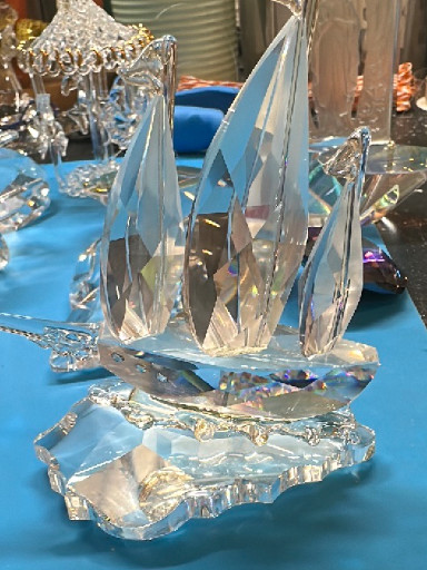 Crystal sailboat sculpture on wave-form base