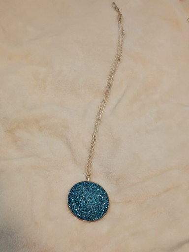 Silver-tone necklace with blue crystal-encrusted circular pendant
