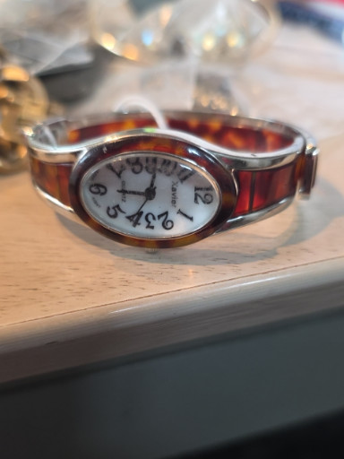 Women's quartz bangle watch with faux tortoiseshell pattern and gold-tone metal