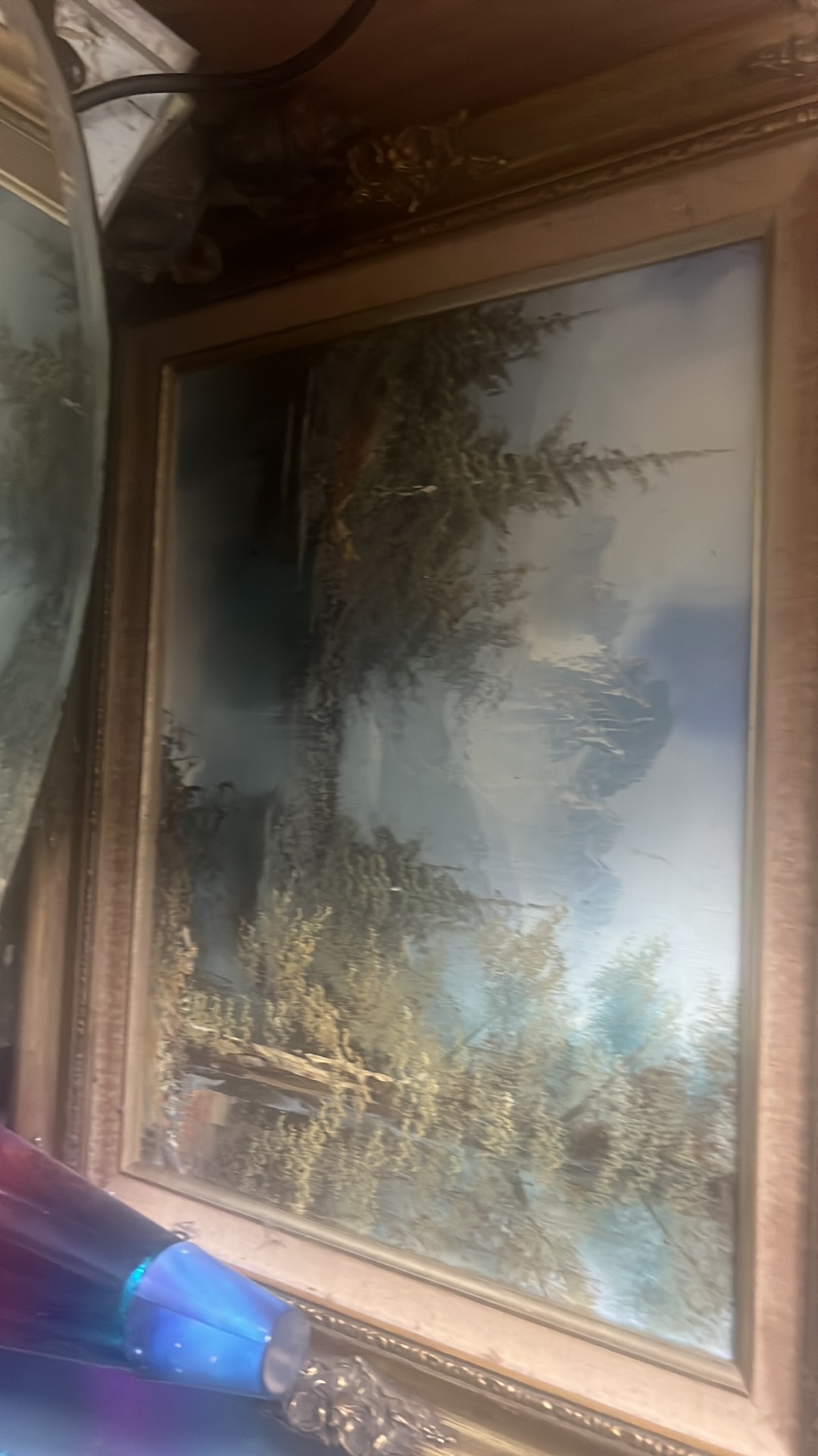 Oil painting of landscape scene in gilt wood frame
