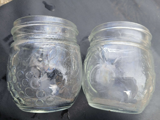 Vintage glass jam and jelly canning jars with embossed grape and fruit decoration