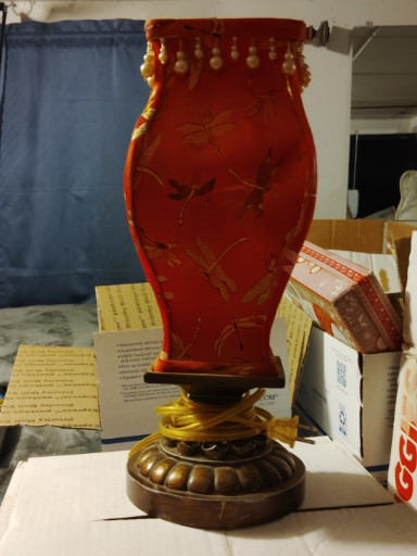 Mid-century decorative table lamp with red lacquered vase-style body and ornamental brass base