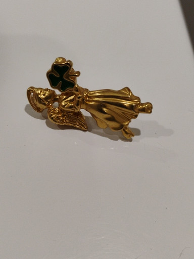 Gold-tone angel brooch with green enamel shamrock by Avon