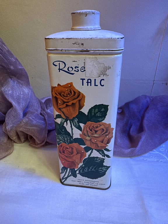 Vintage tin talcum powder container labeled 'Rose Talc' by Velta Distributors