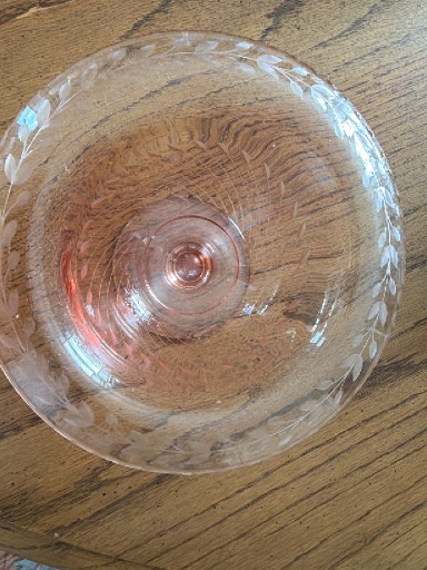 Pink Depression glass bowl with etched floral pattern and scalloped edge