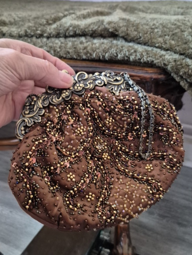 Beaded evening bag with ornate metal frame and chain handle