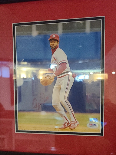 Signed and framed photograph of Hall of Fame baseball player Ozzie Smith in St. Louis Cardinals uniform