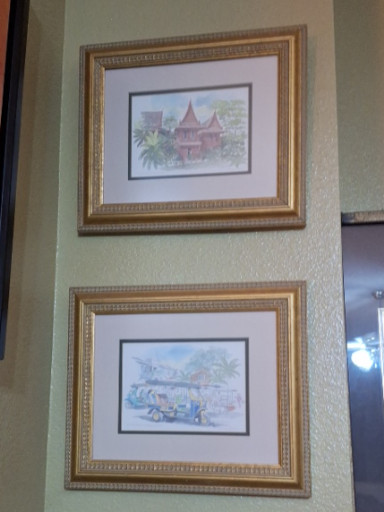Pair of framed watercolor prints depicting traditional Thai architecture
