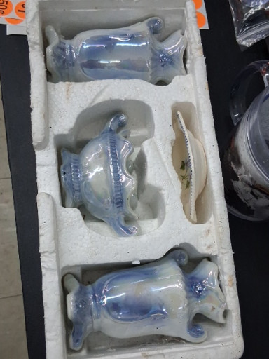 Set of three ceramic blue and white glazed decorative vases or planters with dolphin motifs