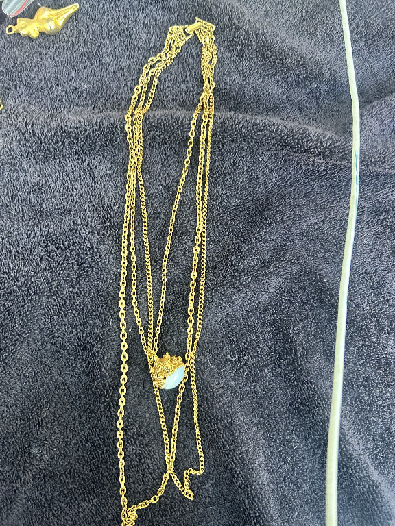 Gold-tone multi-strand chain necklace with decorative pendant