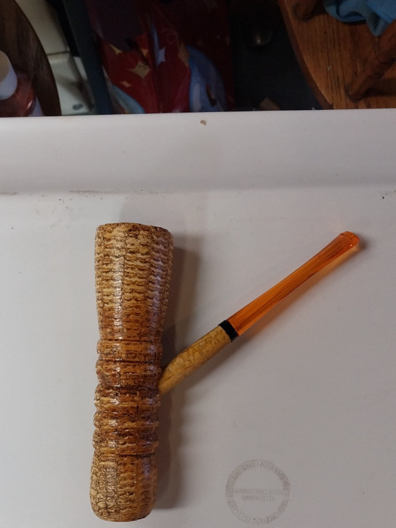 Corn cob pipe with amber-colored stem