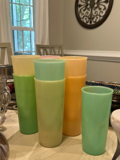 Set of vintage Tupperware pastel tumblers in green, yellow, and orange