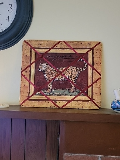 Framed decorative print of a leopard with geometric border design