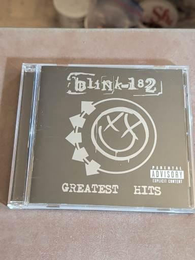 CD album titled 'Greatest Hits' by Blink-182