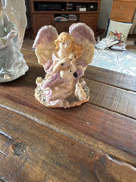 Ceramic figurine of an angel with bunnies by Young's Inc
