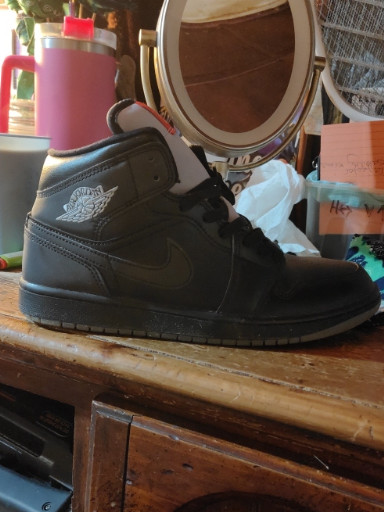 Nike Air Jordan 1 Mid sneaker in black leather
comes in original box