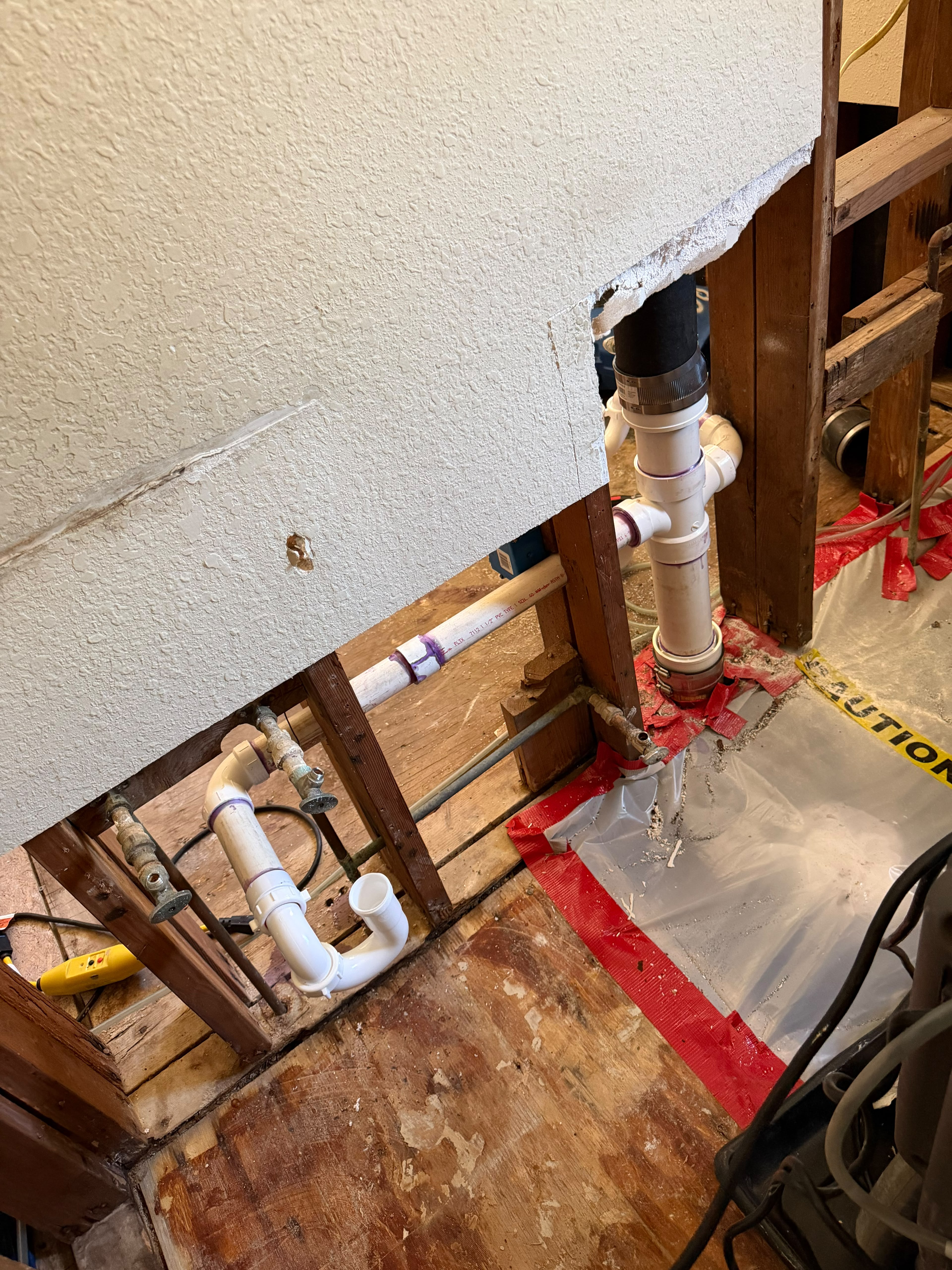 Repeated under-sink water accumulation indicates a leak coming from the kitchen metal drain piping, P-trap, or wall connections. An inspection is required to repair or replace the corroded components, tighten loose fittings, and check the kitchen cabinet for moisture or hidden water damage.
