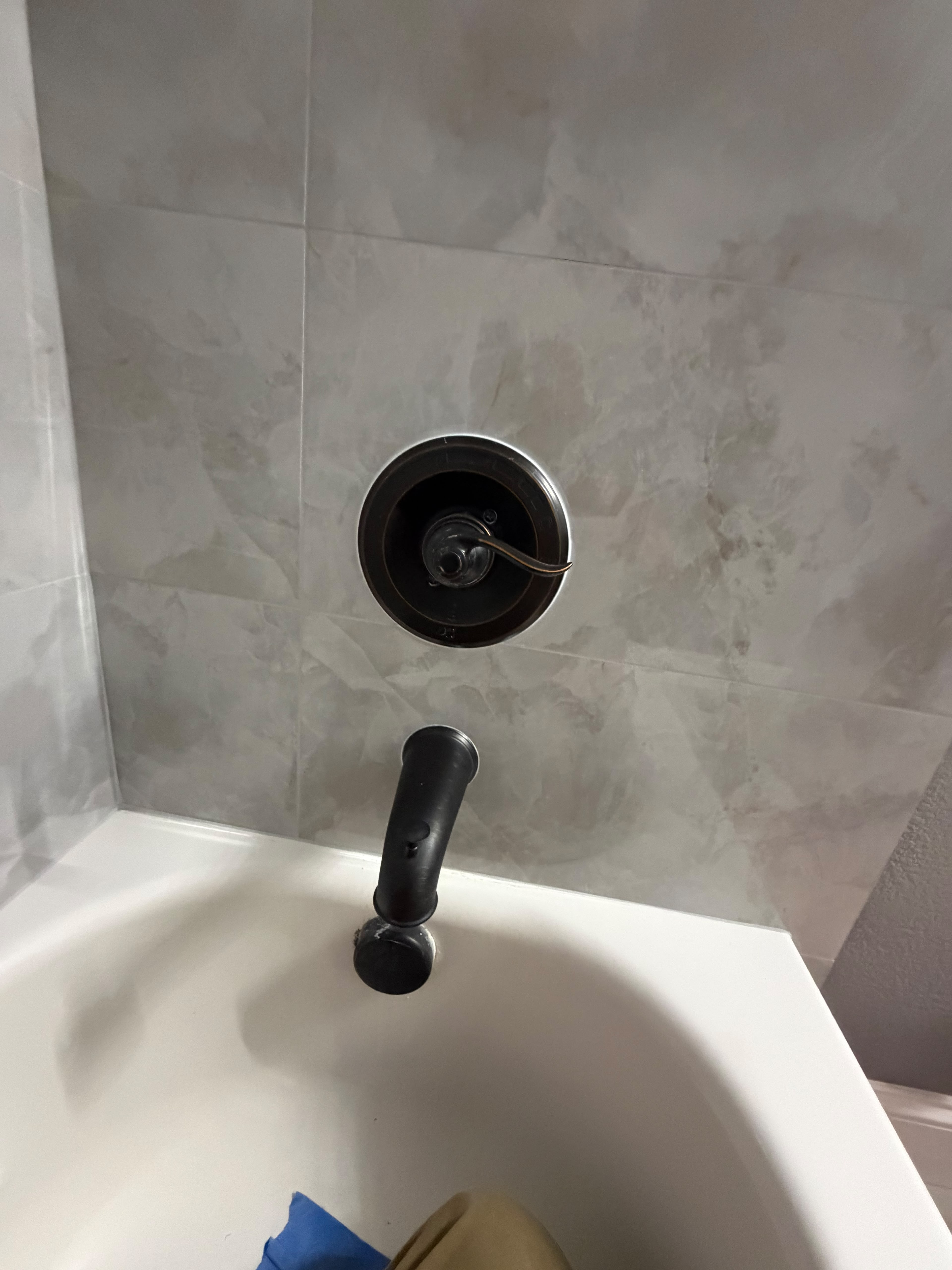 Homeowner reported brown spots on a baseboard adjacent to a bathroom, indicating a potential hidden leak that was previously hidden behind storage bins. An appointment was scheduled for the same day, and the customer agreed to submit photos of the affected area for further evaluation.