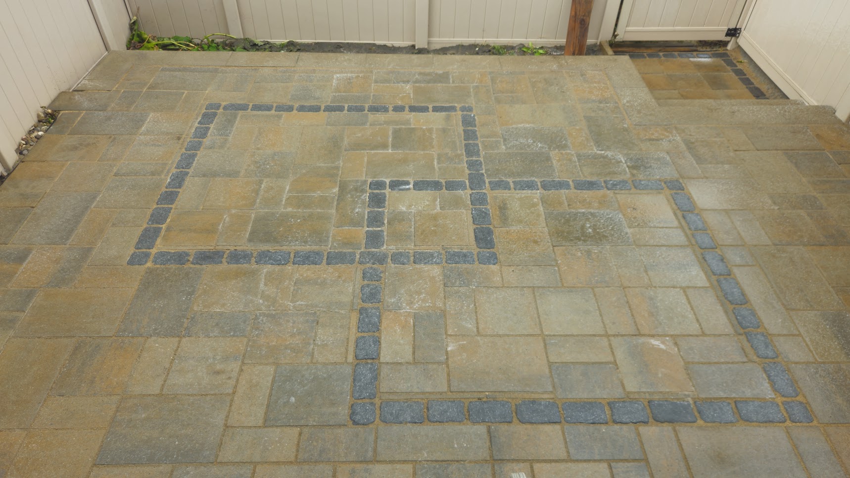 Applying new polymeric sand between interlock pavers.