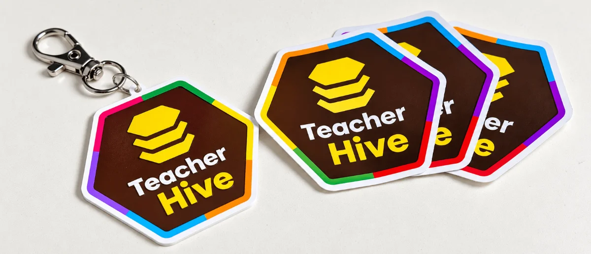 Photo of a 3D printed Teacher Hive keychain and 3 stickers