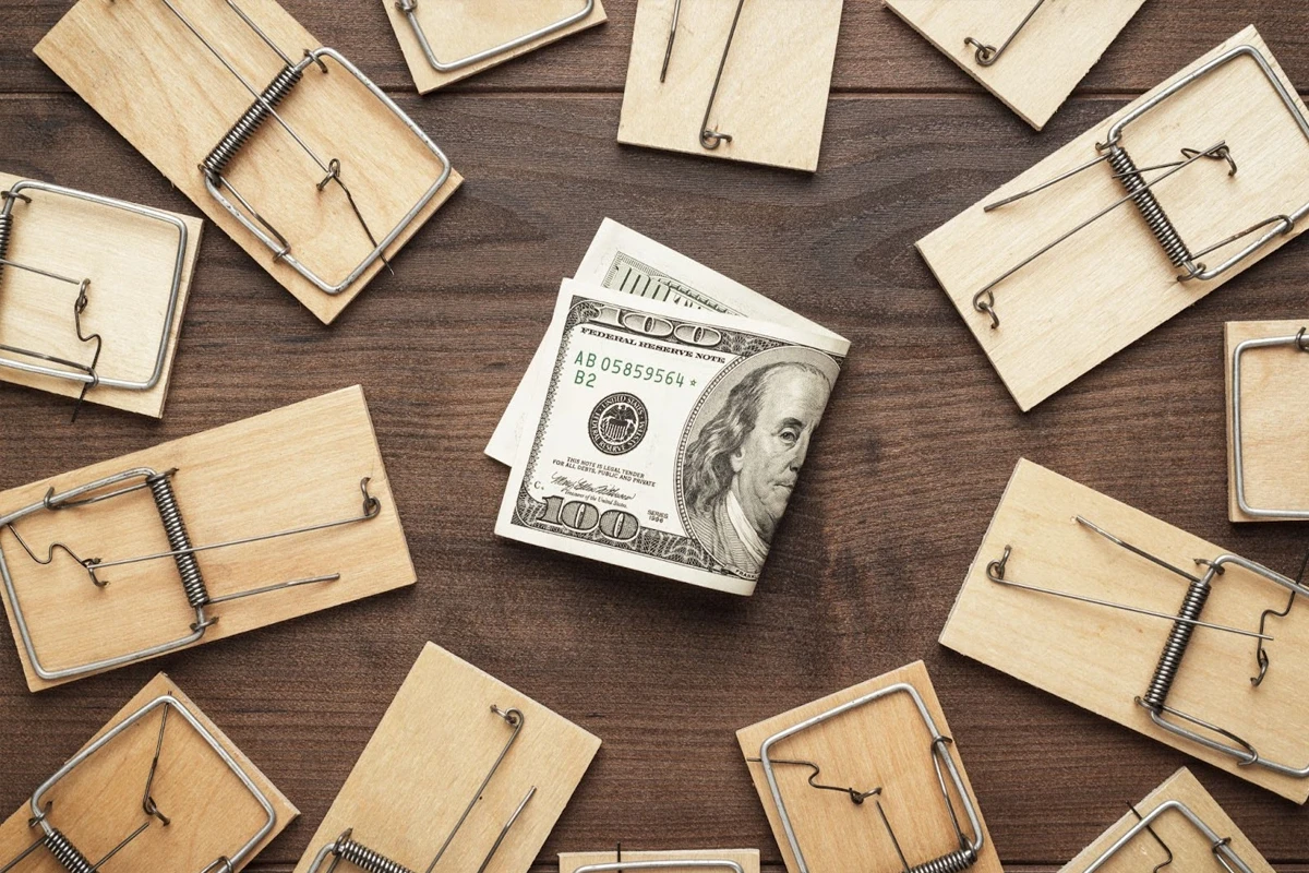 Hundred dollar bill caught in multiple mousetraps
