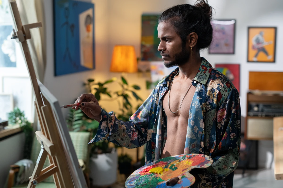 Artist painting on canvas in vibrant studio
