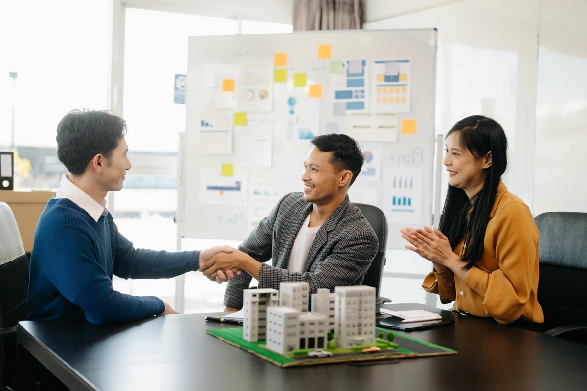 Businesspeople shaking hands in office meeting