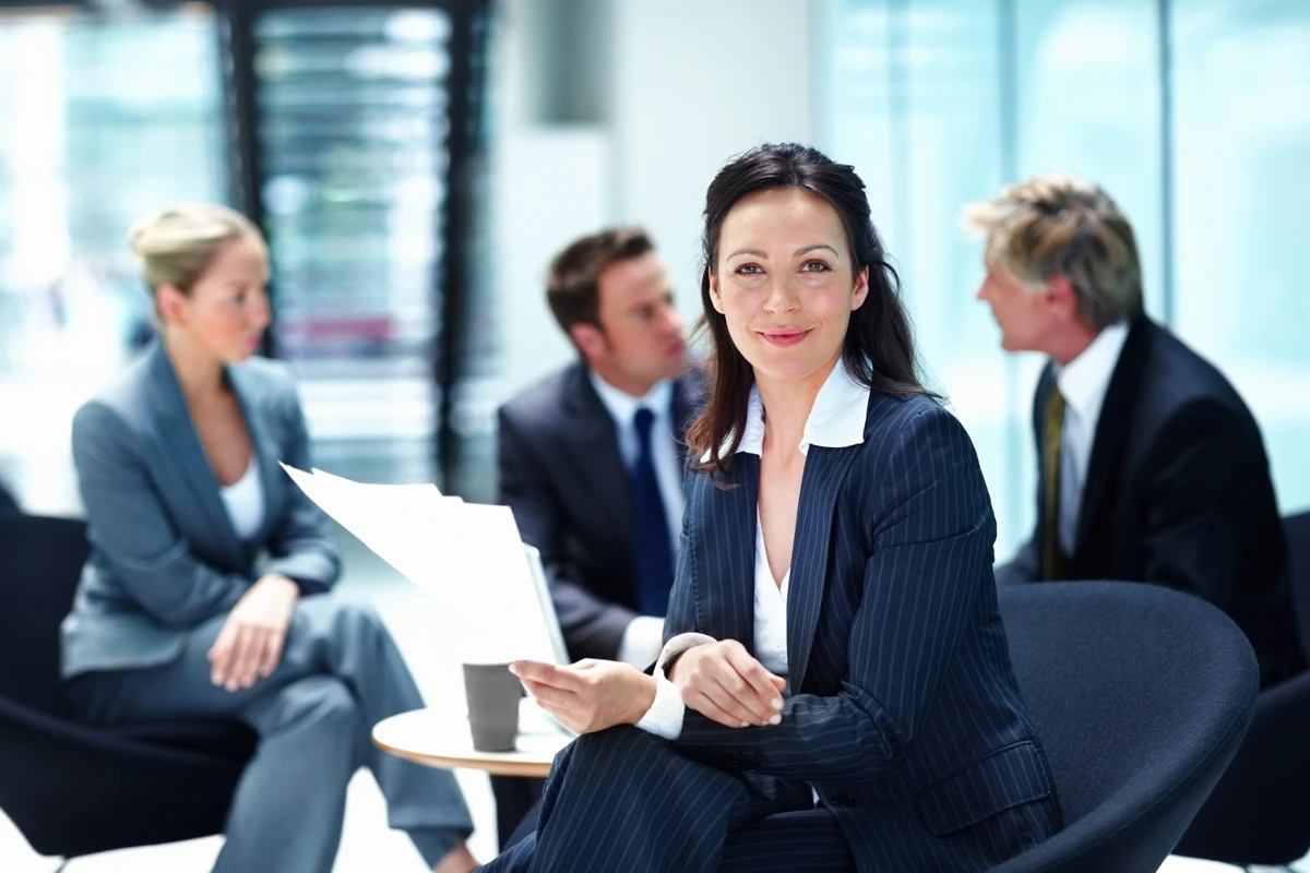 A confident professional reviewing documents, representing how overconfidence can affect investing decisions.