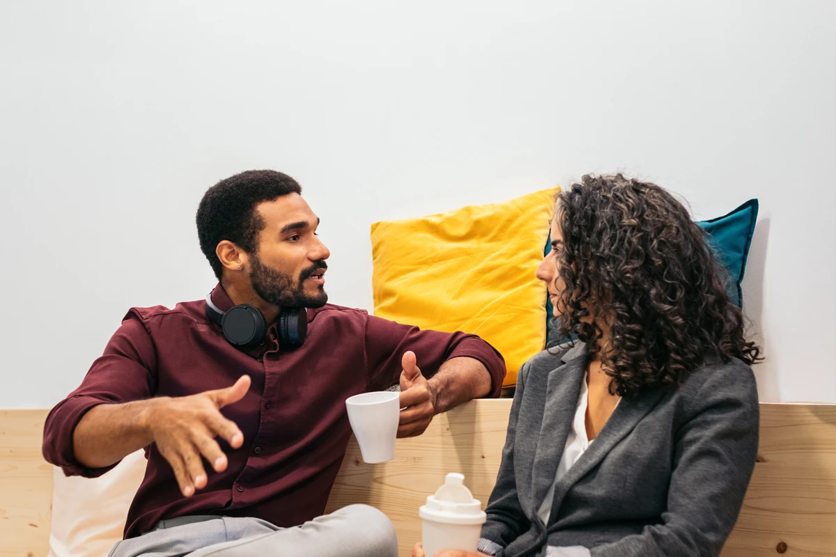 A couple sitting on a sofa discussing their finances and estate planning documents
