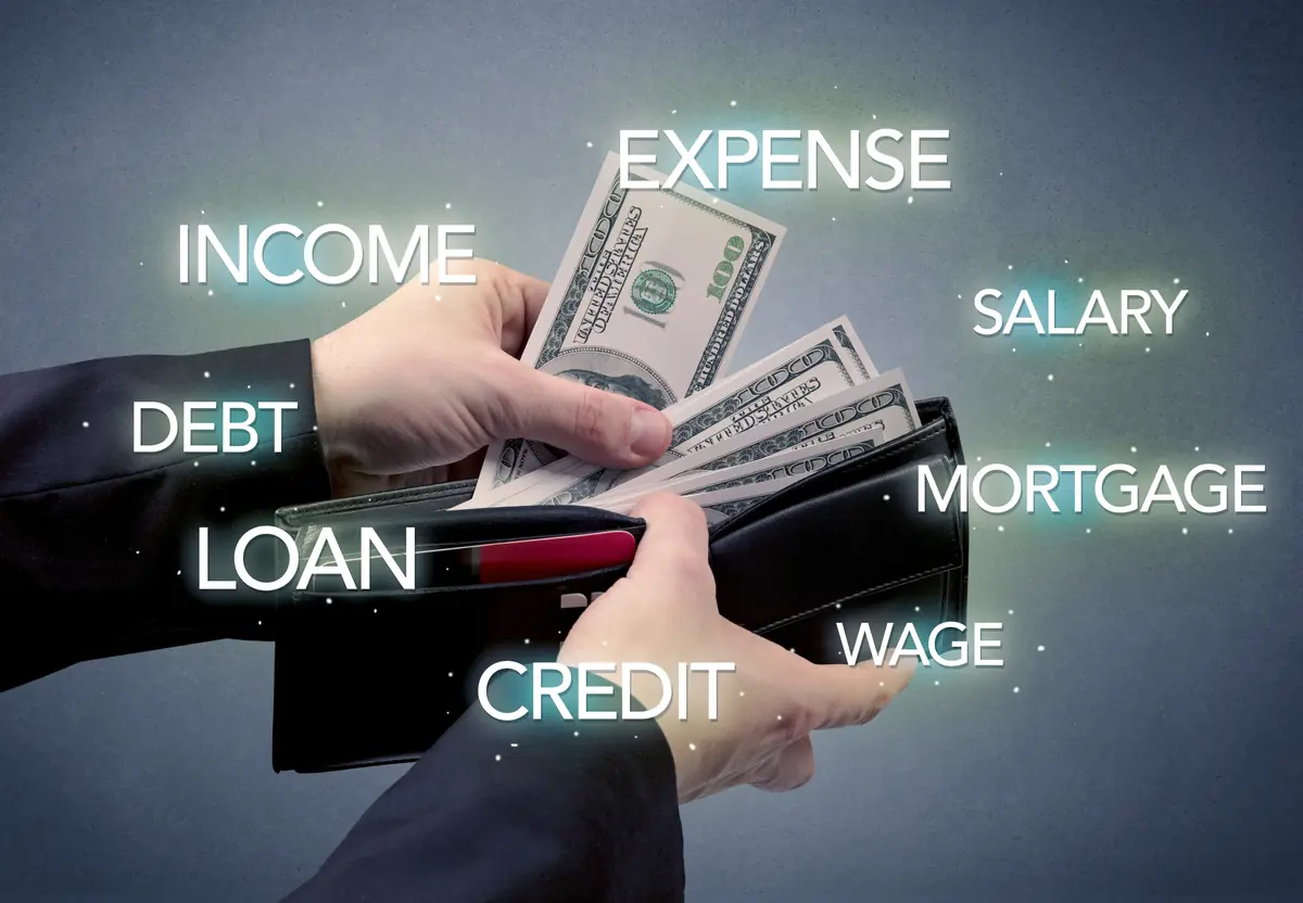 Hands holding an open wallet filled with dollar bills, surrounded by floating words such as income, expense, salary, debt, loan, mortgage, wage, and credit, symbolizing financial concepts.