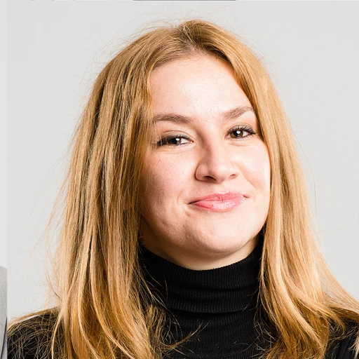 Smiling woman with long blonde hair in black turtleneck