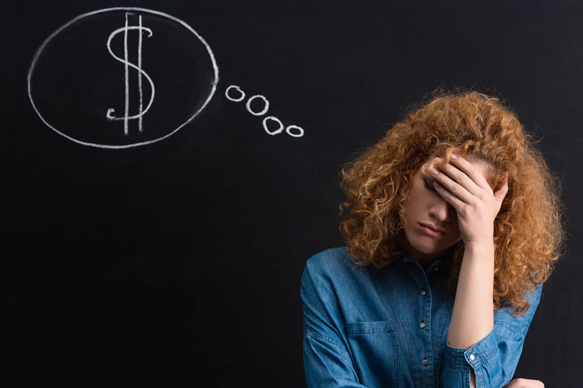 Stressed woman with dollar sign thought bubble