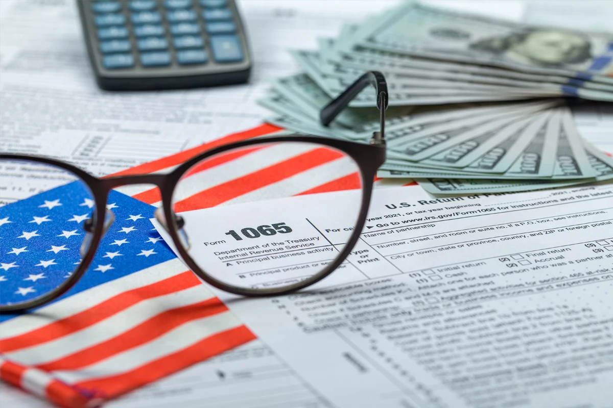 American flag glasses on U.S. tax form 1065 with money