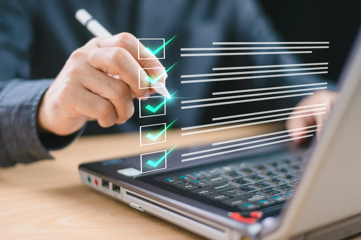 Person checking digital checkboxes on laptop screen