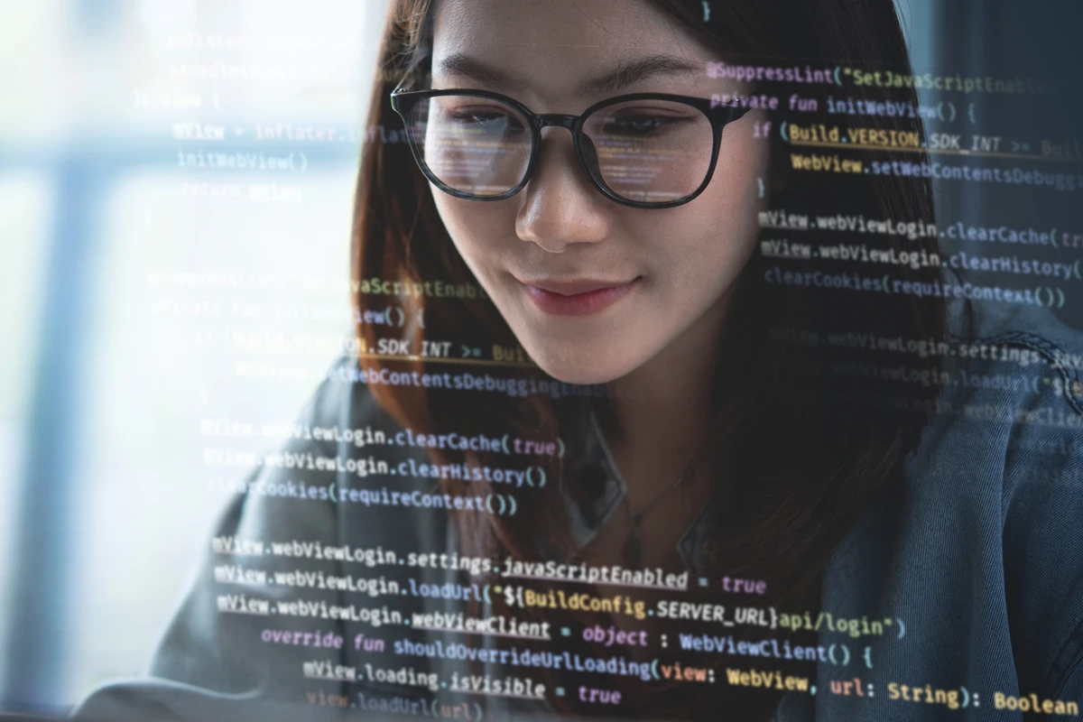 Female programmer coding on computer