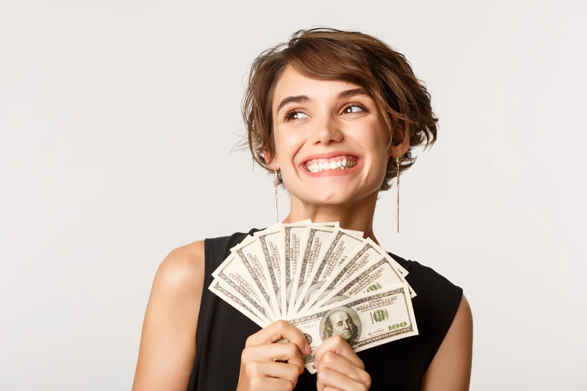Happy woman holding money fan